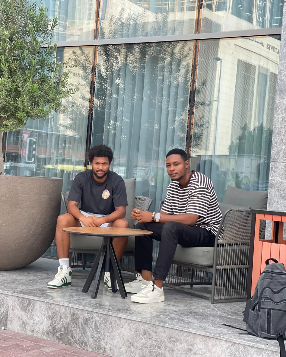 Calid, founder and host of Sofound, seated with a friend during his travels