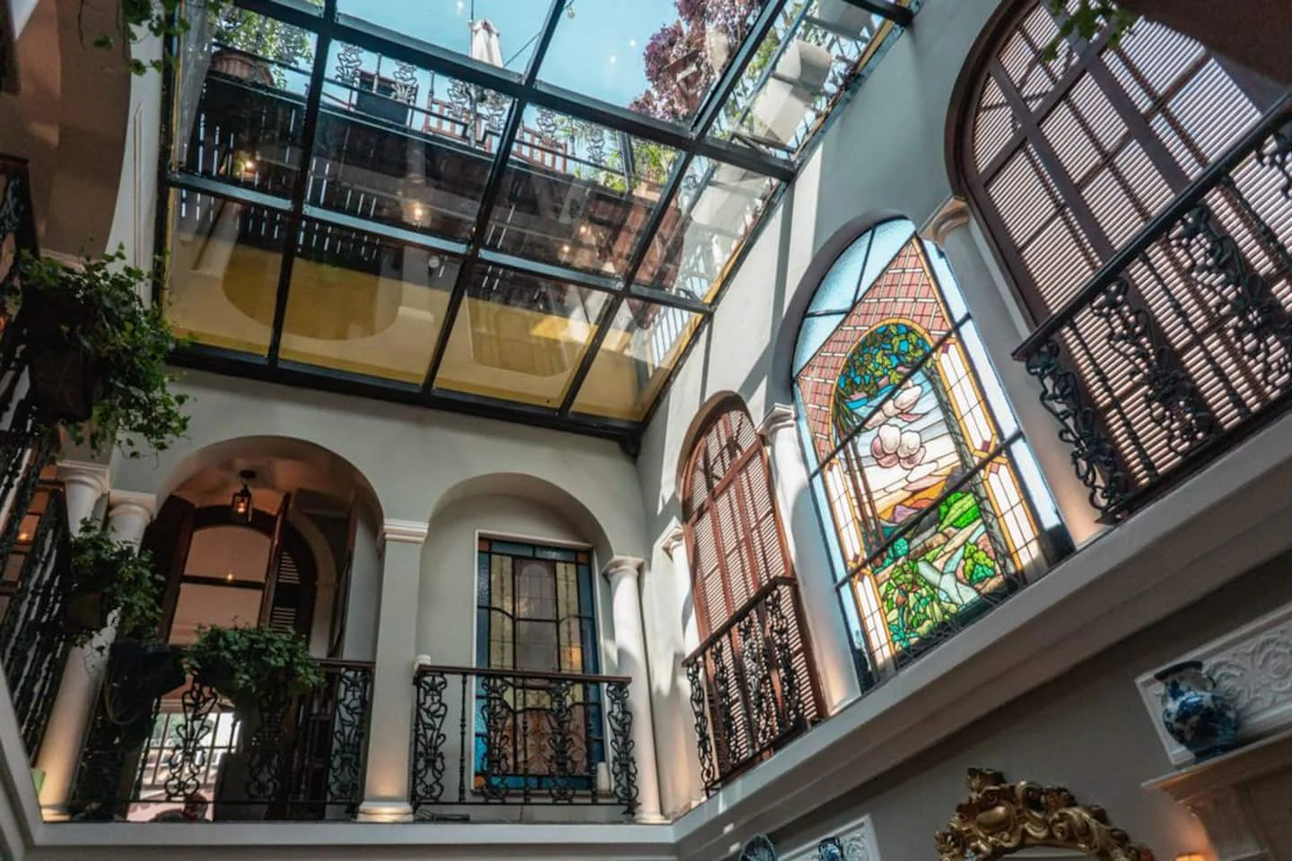 Glass-roofed courtyard with stained-glass windows inside the Sofound Mansion in Rio