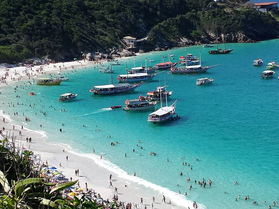Turquoise water, boats, and beach along Rio's coastal escape