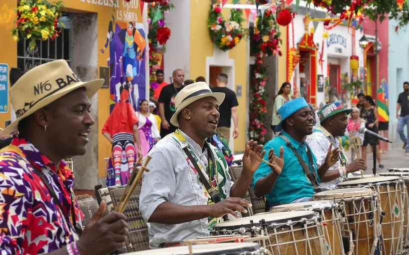 Afro-Brazilian percussionists performing in a colorful Salvador street